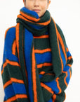 Person wearing a colorful striped scarf on a white background