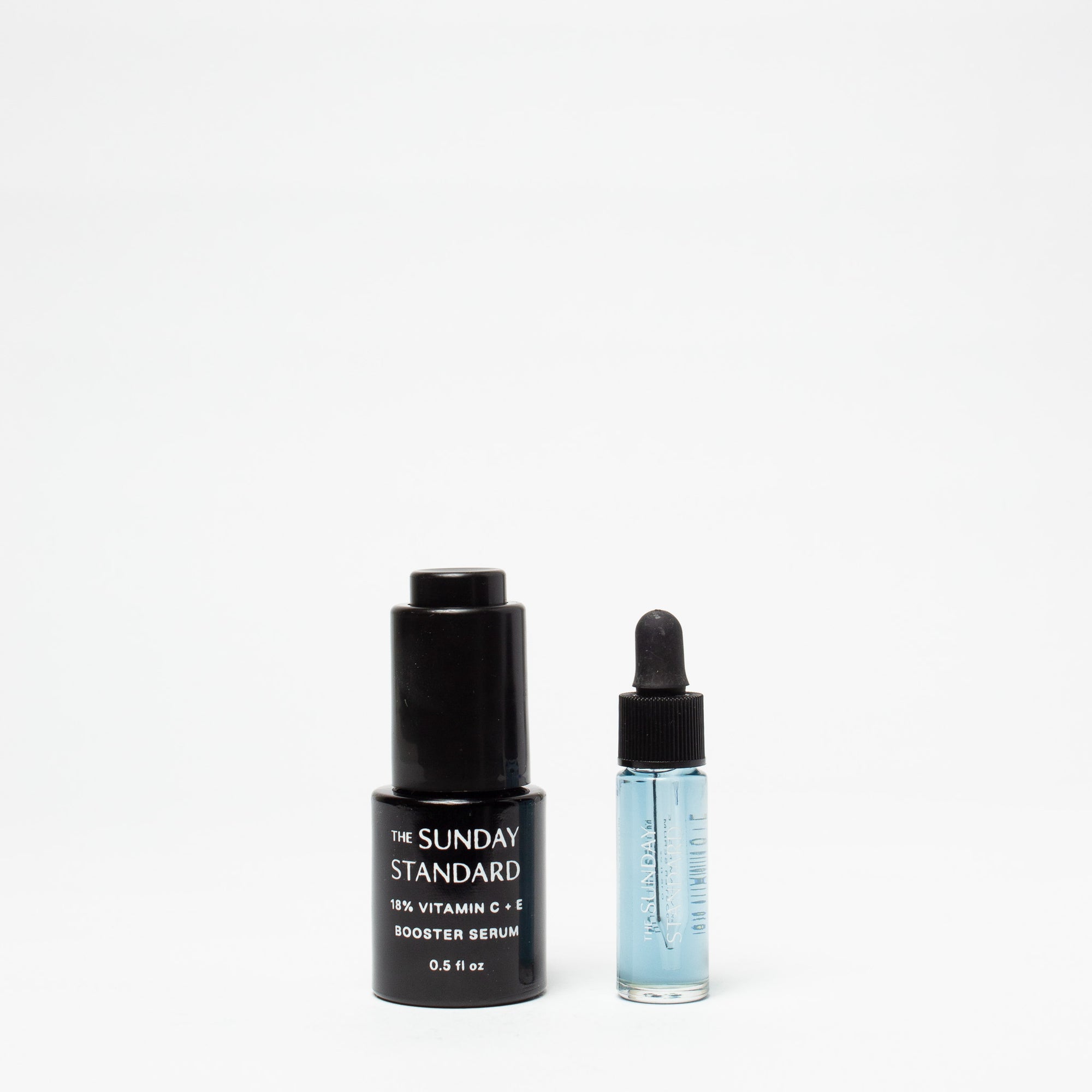 Two skincare bottles from 'The Sunday Standard' on a white background
