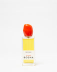 Bodha perfume bottle with red cap on a white background