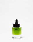 Glass dropper bottle with green liquid on a white background
