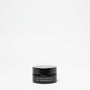 Black jar of Blue Tansy & Bakuchiol product on a white background
