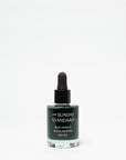 Bottle of The Sunday Standard day oil with dropper on a white background