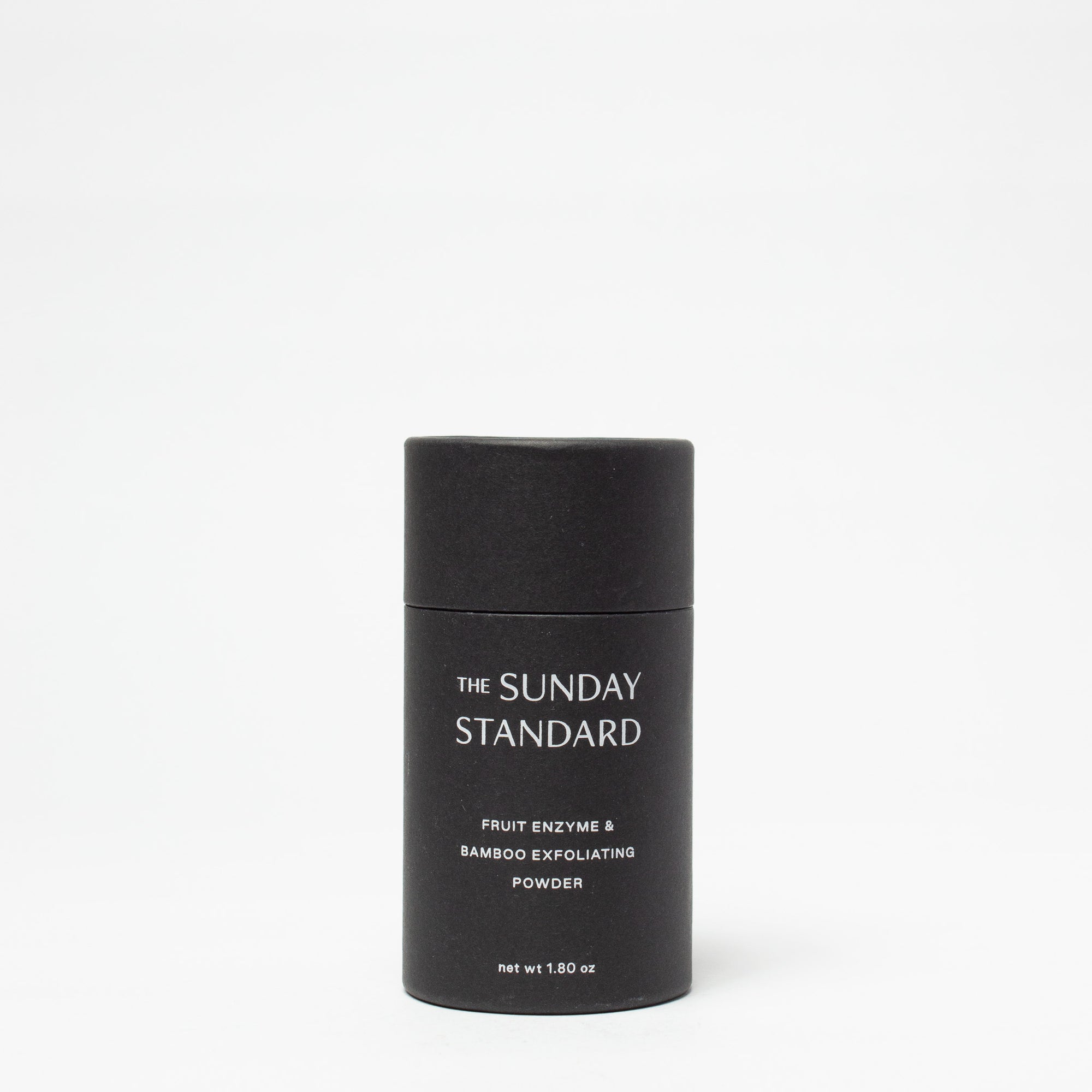 Black container of 'The Sunday Standard' powder on a white background