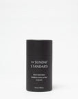 Black container of 'The Sunday Standard' powder on a white background
