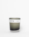 Candle with a 'NETTE' label on a white background