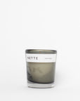 Candle in a glass jar with a white label on a white background
