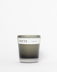 Candle with 'NETTE' label on a white background