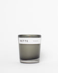 Gray candle with a white label on a white background