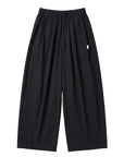 The Sunday Standard black cotton parachute pants with an elastic waist, side pockets, and a wide-leg sculptural fit.