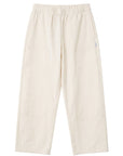 The Sunday Standard Gardener's Pants in cream cotton-nylon with an elastic waist, tapered leg, and utility patches.